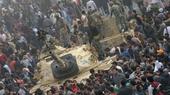 A crowd surrounding an Egyptian military tank at Tahrir Square in Cairo (photo: dpa)