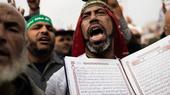 A supporter of Mohamed Morsi holds a Koran during a demonstration in Cairo (photo: AFP/Getty Images)