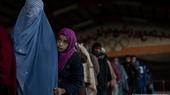 Women queue up for cash at a World Food Program site in Kabul, Afghanistan, November 20, 2021.