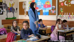 Children and their teacher in a Turkish primary school classroom