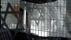 A broken pane of glass with the Jewish star after an attack on a synagogue in Istanbul