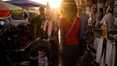 A family walks through a market