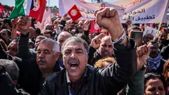 Participants in a protest waved the Tunisian flag and raised banners demanding union rights, social and economic rights, and social dialogue in the country.