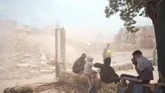 Young men watch the demolition of home. (Photo: Yassine Toumi)