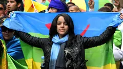 In this April 22, 2012, photo, an activist carries the Berber flag during a march calling for greater rights and autonomy in the Moroccan city of Casablanca, April 2012.
