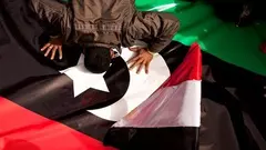 An Egyptian demonstrator on Tahrir Square in Cairo kisses the new Libyan flag out of solidarity with the rebels in Egypt (photo: AP)