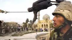 Iraqi civilians and U.S. soldiers pull down a statue of Saddam Hussein in downtown Baghdad, 9 April 2003 (photo: AP/Jerome Delay)