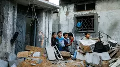 Palestinian boys stand next to the destroyed house of Hejazi family after what Hamas Health Ministry said was an Israeli air strike in the northern Gaza Strip November 20, 2012 (photo: Reuters)