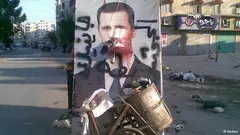 A defaced poster of President Assad in Aleppo (photo: Reuters)