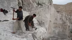Afghan workers dig for mineral resources.