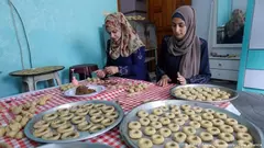 Baking Eid sweets in Gaza: cookies filled with dates, mixed nuts or a mix of honey and sesame seeds are another quintessential Eid delicacy across the Middle East. Baking the cookies, which are called kakh, is a key social activity, with many families gathering to make and decorate the cookies ahead of Eid, as here in Gaza