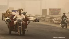 People ride during a sandstorm in the town of Khalis in Iraq's Diyala province on 3 July: the country of 41 million, despite the mighty Tigris and Euphrates rivers, is suffering from water shortages and declining rainfall.