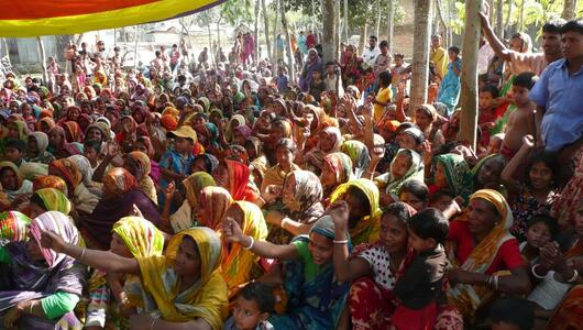Large group of women in Bangladeshi attire gathered together outside