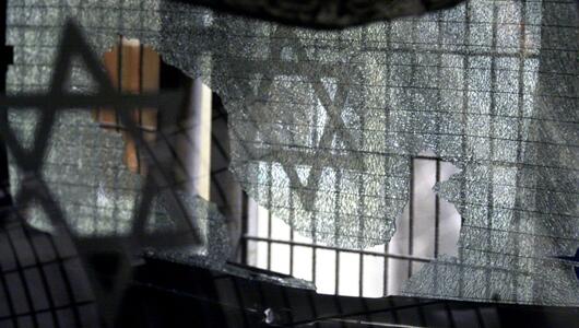 A broken pane of glass with the Jewish star after an attack on a synagogue in Istanbul