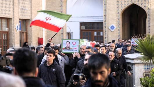 Iranian worshippers carry a coffin containing the body of an Islamic Revolutionary Guard Corps (IRGC) general, Sadegh Zakeri-Kia, during a funeral after an Eid al-Fitr mass prayer ceremony at a holy shrine in the Shahr-e Rey neighborhood in southern Tehran, Iran, on March 21, 2026. 