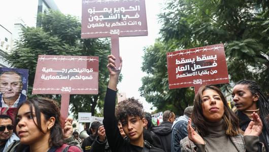 A group of female demonstrators holding signs.